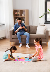 Image showing happy sisters doing arts and crafts at home