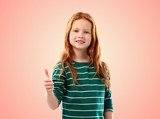 Image showing smiling red haired girl showing thumbs up