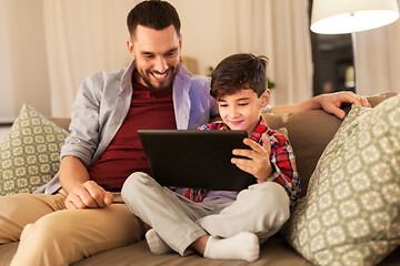 Image showing father and son with tablet pc playing at home