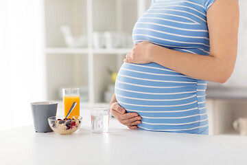 Image showing close up of pregnant woman touching her belly