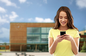 Image showing teenage girl using smartphone over school