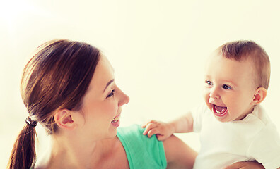 Image showing happy young mother with little baby at home