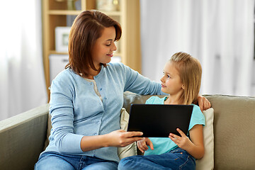 Image showing happy mother and daughter with tablet pc at home