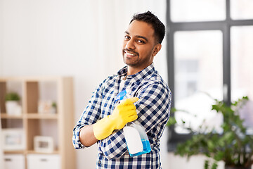 Image showing smiling indian man with detergent cleaning at home