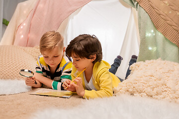 Image showing boys with magnifier and map in kids tent at home