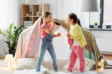 Image showing girls with guitar and microphone playing at home