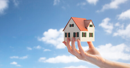 Image showing close up of hand holding house or home model