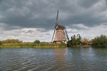 Image showing Windmill beside a canal