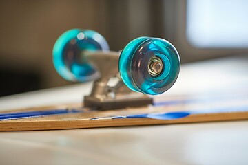 Image showing Skateboard on a table, wheel closeup focus