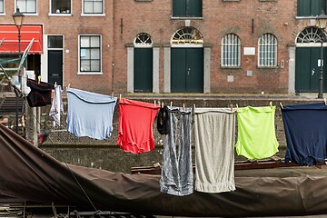 Image showing Clothes Hanging Outside near a canal