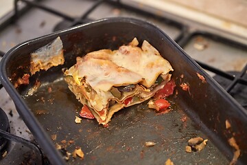 Image showing Lasagna leftover in a dirty kitchen