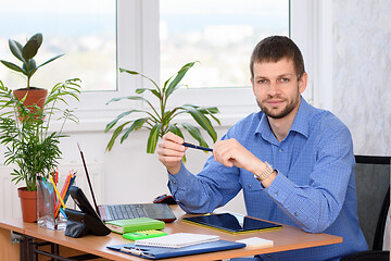 Image showing Portrait of an office specialist at a desk in an office