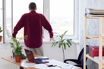 Image showing The office specialist looked out the window at lunchtime