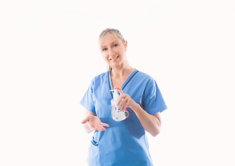 Image showing Nurse holding and demonstrating hand hygiene alcohol rub