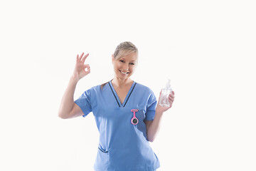 Image showing Nurse recommending use of hand sanitizer alcohol rub for hand hygiene