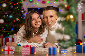 Image showing Christmas happy girl and young man smile, look in the frame