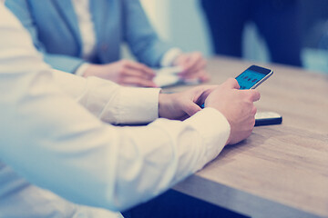 Image showing Young casual businessman using smartphone