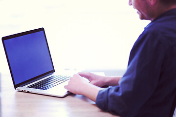 Image showing businessman working using a laptop in startup office