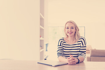 Image showing Young woman with laptop at home