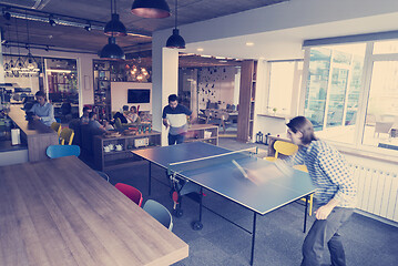 Image showing playing ping pong tennis at creative office space