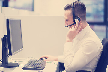 Image showing male call centre operator doing his job