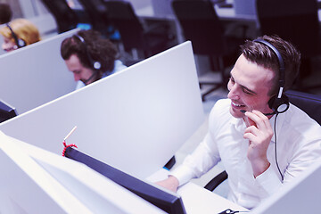 Image showing male call centre operator doing his job