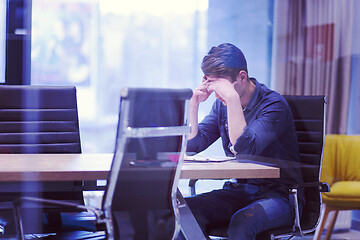 Image showing young businessman relaxing at the desk