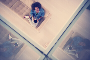 Image showing african american woman at home with digital tablet top view