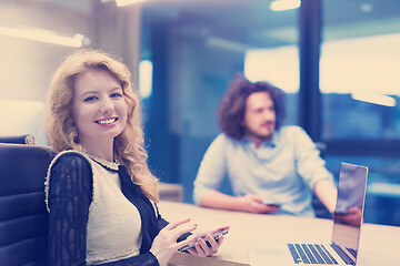 Image showing Elegant Woman Using Mobile Phone in startup office building