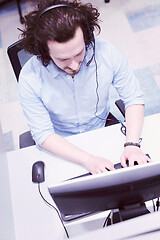 Image showing male call centre operator doing his job top view