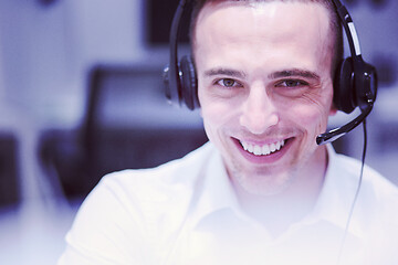 Image showing male call centre operator doing his job