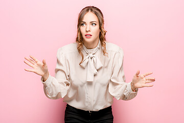 Image showing Beautiful woman looking suprised isolated on pink