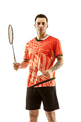 Image showing Young male badminton player over white background