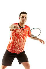 Image showing Young male badminton player over white background