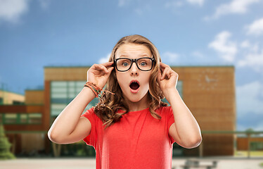 Image showing surprised teenage girl in glasses over school