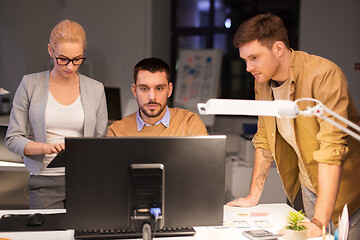 Image showing business team with computer working late at office