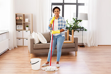 Image showing african woman or housewife cleaning floor at home