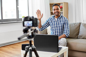 Image showing male blogger with camera videoblogging at home