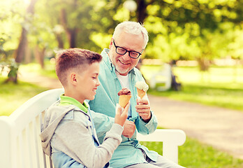 Image showing old man and boy eating ice cream at summer park