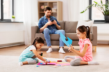 Image showing happy sisters doing arts and crafts at home