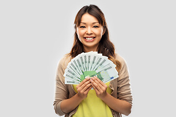 Image showing asian woman with hundred euro money banknotes