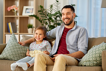 Image showing happy father and daughter watching tv at home