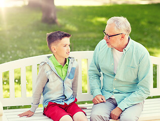 Image showing grandfather and grandson talking at summer park