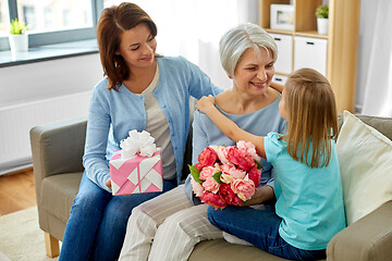 Image showing granddaughter hugging and greeting grandmother