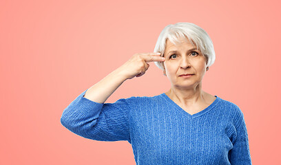 Image showing senior woman making finger gun gesture