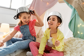 Image showing girls with pots playing in kids tent at home