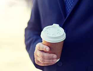 Image showing senior businessman with coffee cup outdoors