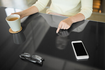 Image showing woman with coffee using black interactive panel