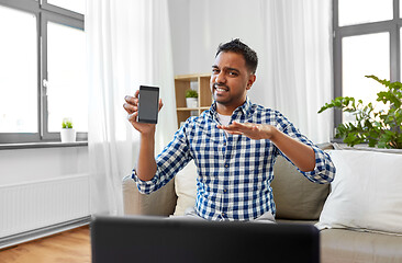 Image showing male blogger with smartphone videoblogging