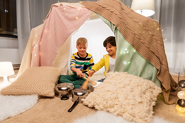 Image showing boys with pots playing music in kids tent at home